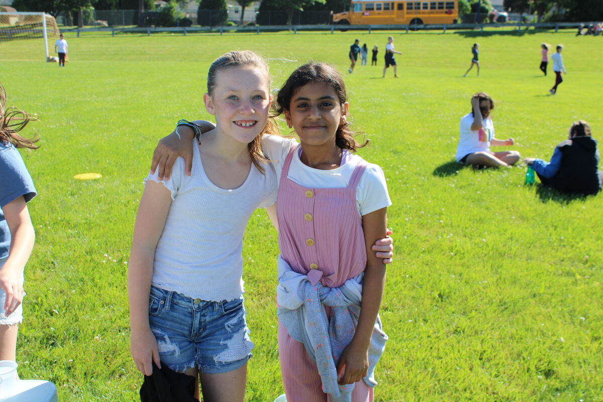students play field day games outdoors on grass