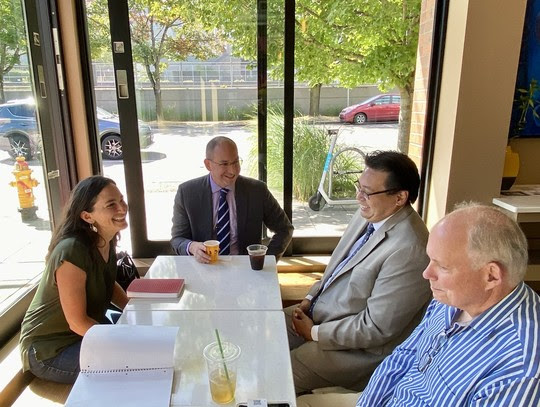 people seated at a table over coffee