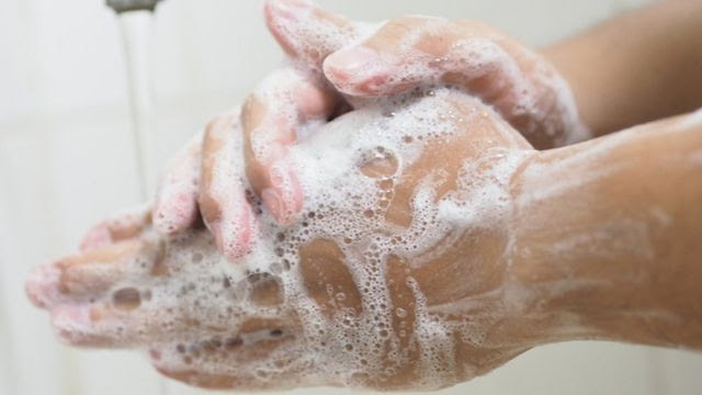 A person washing their hands.