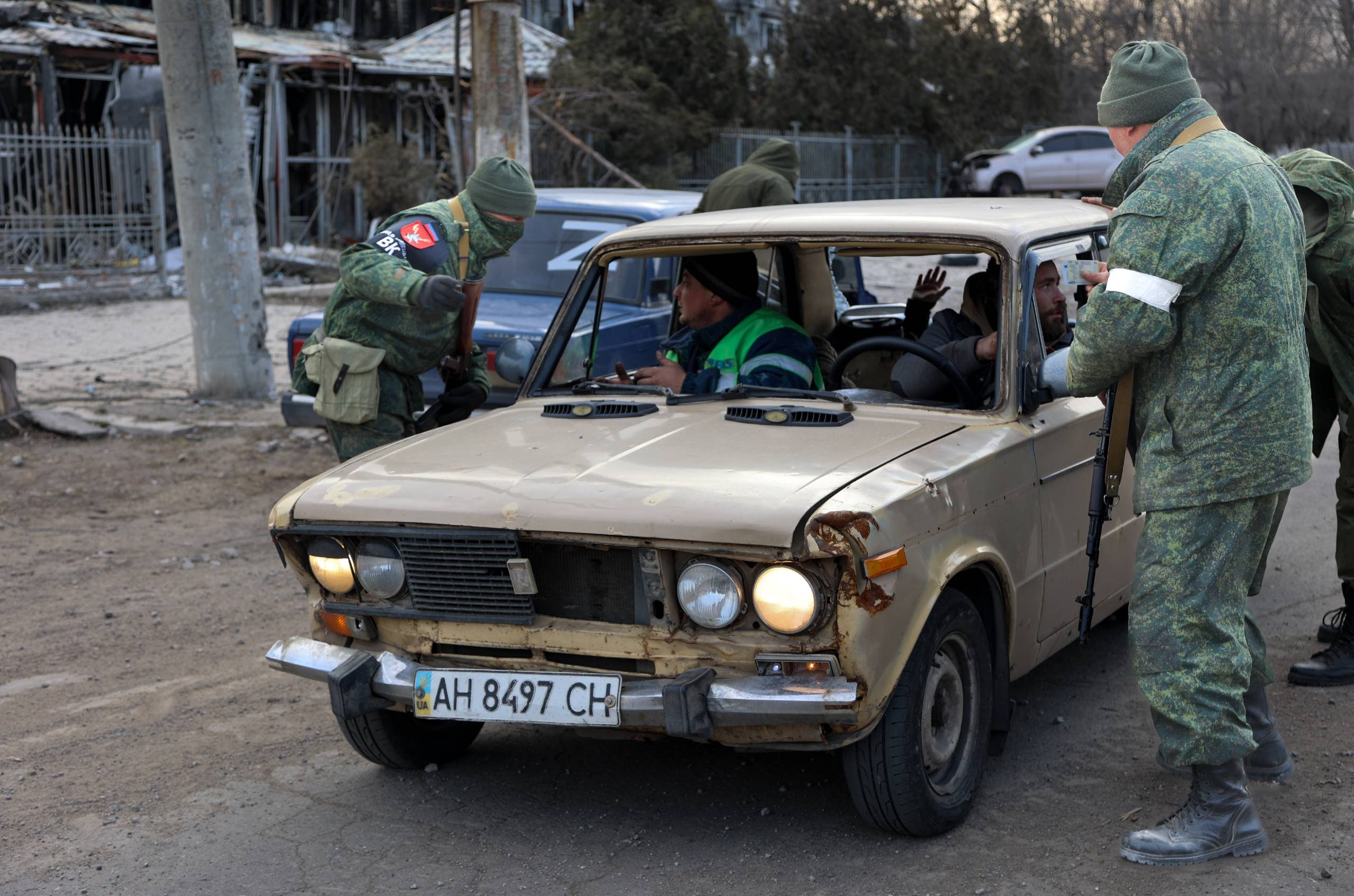 Servicemen of Donetsk People's Republic inspect a vehicle at a checkpoint on the outskirts of Mariupol, the territory which is under the Government of the Donetsk People's Republic control.