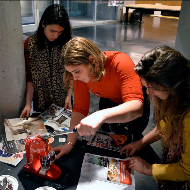 Three students make buttons with a button-making machine
