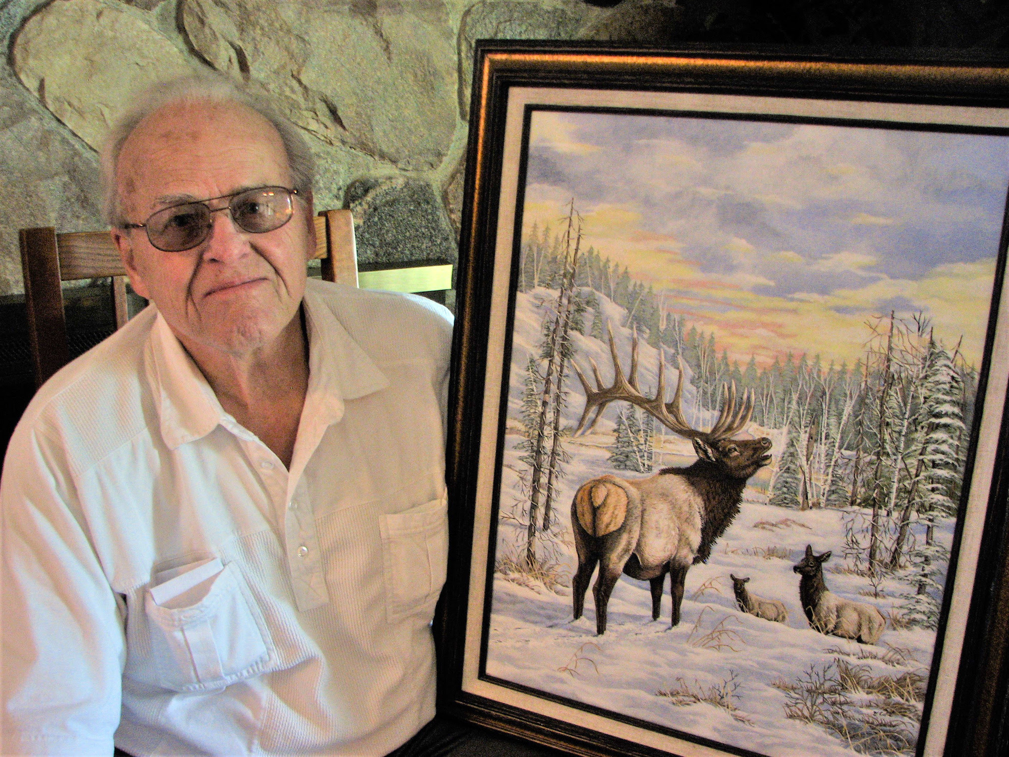 Gary Cole of Dearborn, shown here with his acrylic painting of elk, was the winner of the 100th anniversary of elk poster contest.