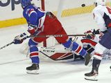 New York Rangers center Mika Zibanejad, upper left, scores in overtime against Washington Capitals goaltender Ilya Samsonov as Capitals right wing Tom Wilson (43) defends during an NHL hockey game Thursday, March 5, 2020, in New York. Zibanejad had five goals as the Rangers won 6-5. (AP Photo/Kathy Willens)