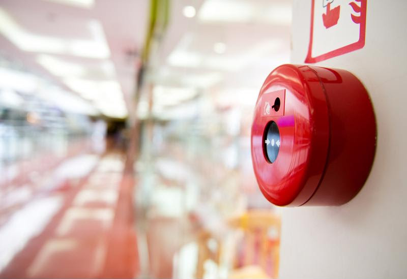 A fire alarm on a facility wall.