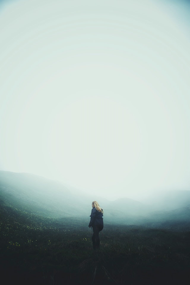 woman walking into fog