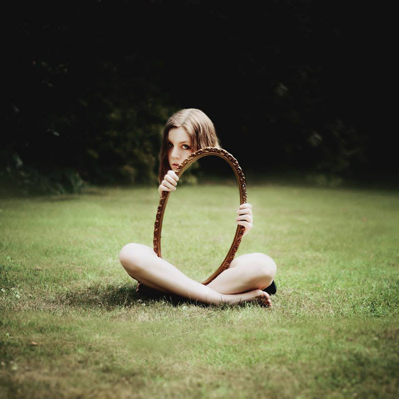 http://twistedsifter.com/2013/09/laura-williams-self-portrait-holding-mirror-grass/
