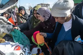 Doação de roupa perto da cidade de Edirne, na fronteira entre entre a Grécia e a Turquia, em março de 2020, quando milhares de migrantes retidos na Turquia por causa do acordo de 2016 com a UE correram à fronteira, que os turcos abriram momentaneamente