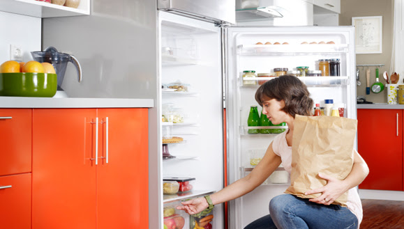 Woman putting away groceries