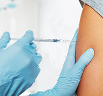 Clinician vaccinating an adult