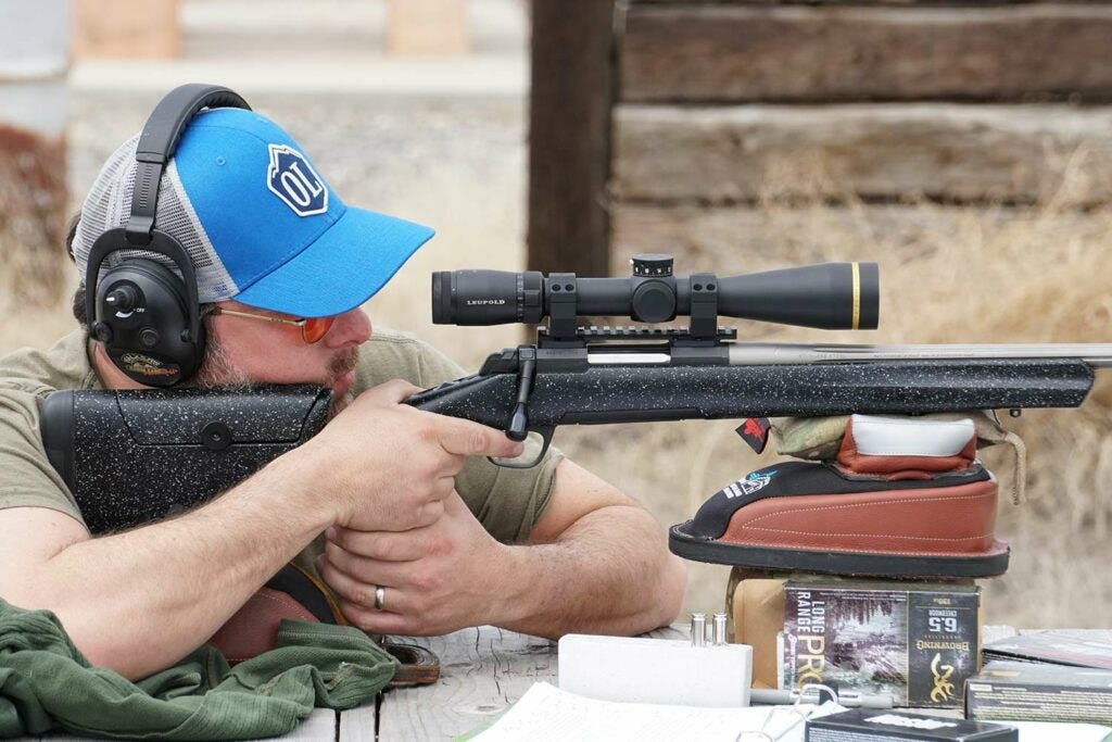 man aiming a hunting rifle