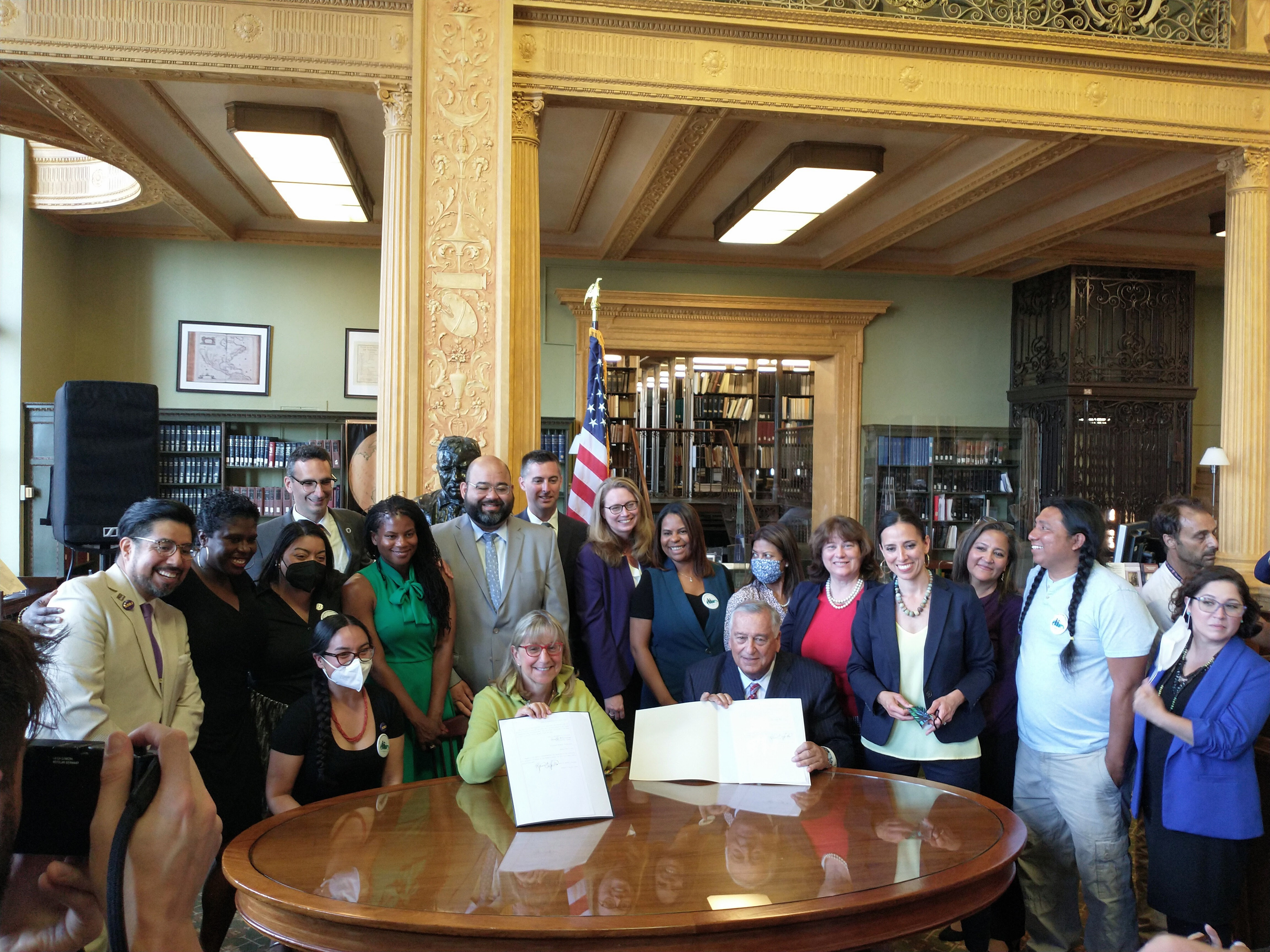 Driving Families Forward Coalition leaders with legislative champions at historic signing ceremony for the Work and Family Mobility Act on June 13, 2022.