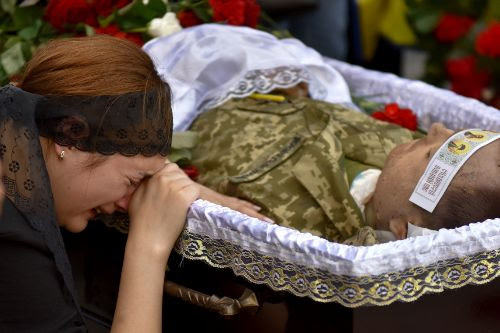 Kyiv (Ukraine).- Relatives, friends and comrades attend a funeral...