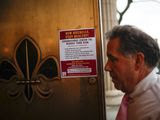 A sign providing instructions on how to reduce the risk of contracting or spreading COVID-19 is hung on the front door of New Rochelle City Hall, Tuesday, March 10, 2020, in New Rochelle, N.Y. State officials are shuttering schools and houses of worship for two weeks in part of the New York City suburb New Rochelle and sending the National Guard there to help respond to what appears to be the nation&#39;s biggest cluster of coronavirus cases. (AP Photo/John Minchillo)