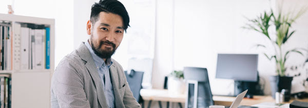 Asian man on computer at home