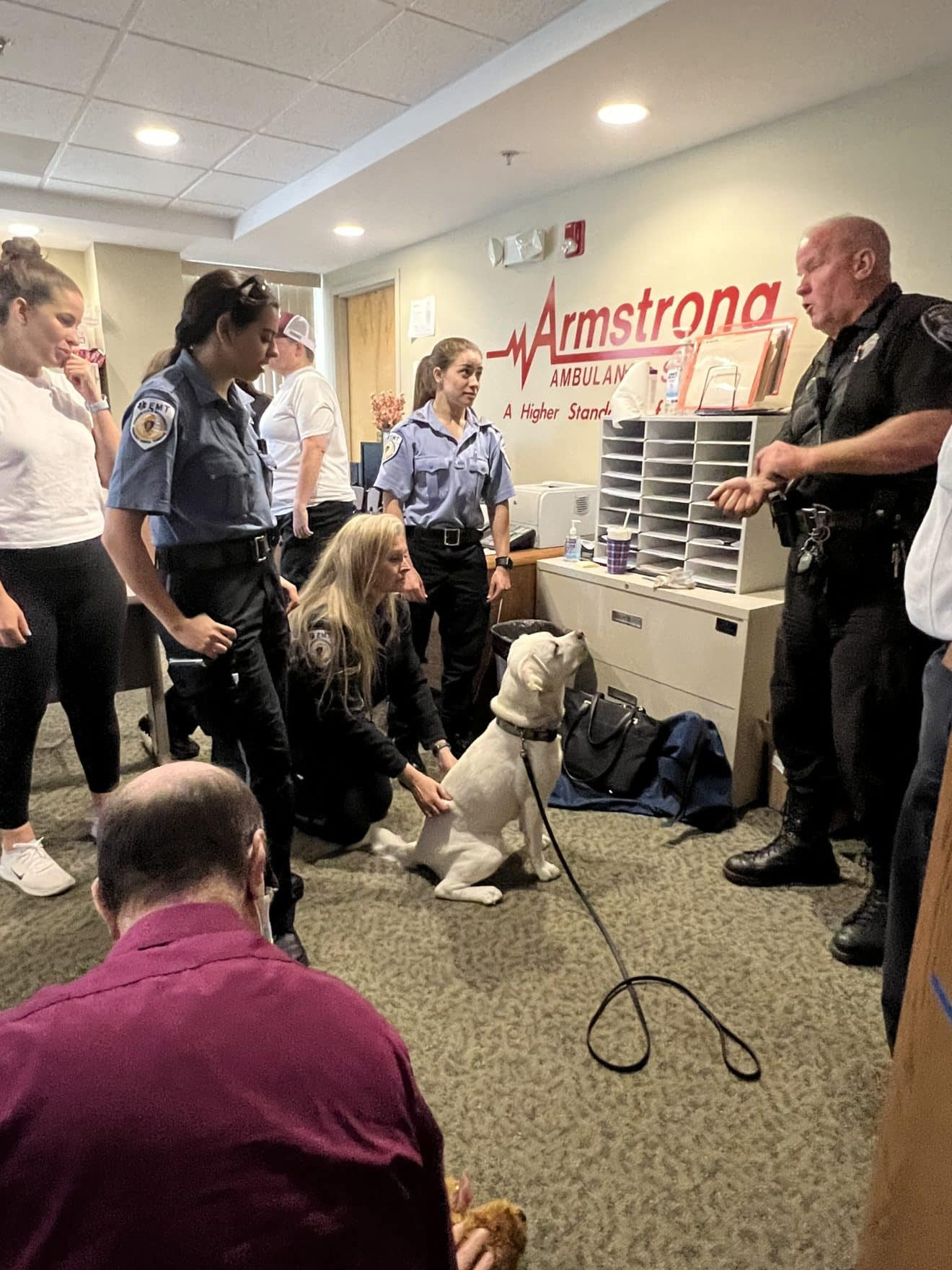 Arlington Police K-9 Officer Mike Hogan right) and his personal dog, Ivy, joined in Armstrong Ambulance's K-9 first aid training. / Armstrong Ambulance photos