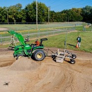 Tractor grading a baseball field at Sammons Park