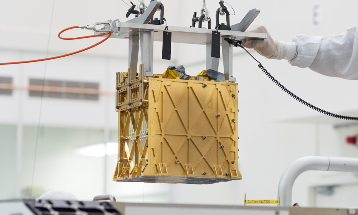 The MOXIE instrument is lowered into the rover in the clean room.