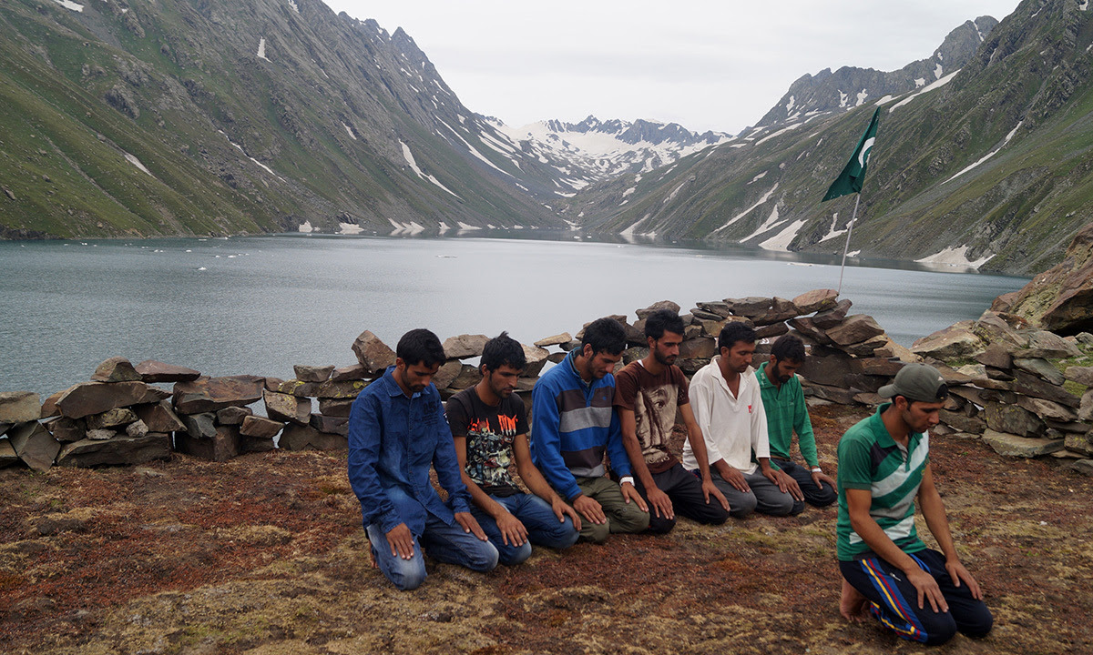 Kashmiri Muslims praying after trekking the mountains to reach the pictureseque Kounsarnag Lake. — Haziq Qadri