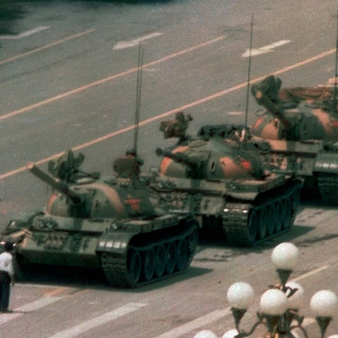 In this iconic 1989 photo, a Chinese man stands alone to block a line of tanks heading east on Beijing's Changan Blvd. in Tiananmen Square.