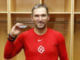 Washington Capitals&#39; Alex Ovechkin poses with the puck commemorating his 700th career NHL goal that he scored against the New Jersey Devils in the third period at Prudential Center on Saturday, Feb. 22, 2020, in Newark, New Jersey. (Patrick McDermott/NHLI Pool Photo via AP) ** FILE **