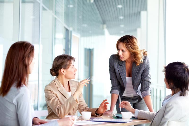 Businesspeople discuss ideas at a meeting.