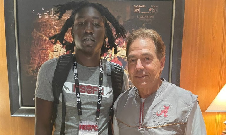 Yhonzae Pierre takes picture with Nick Saban during visit