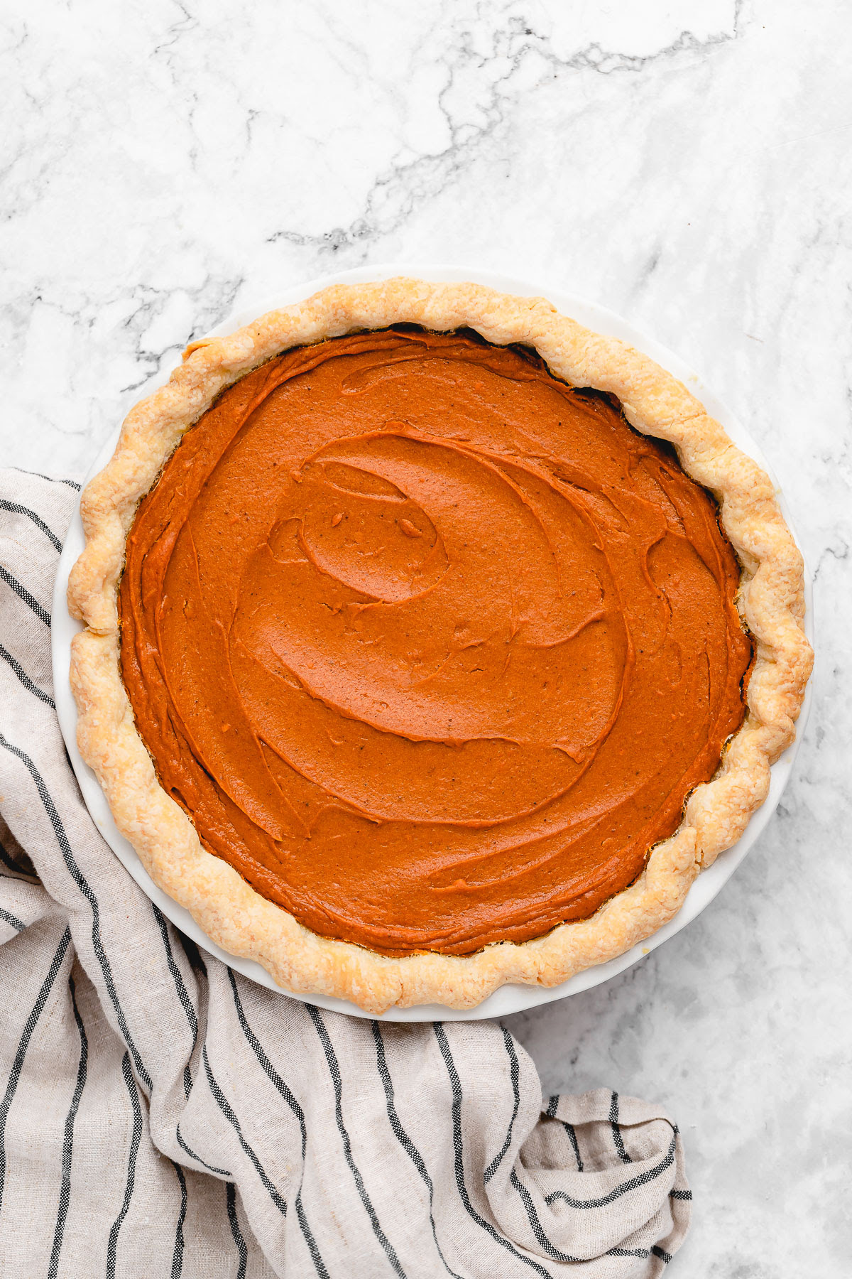 This Vegan Sweet Potato Pie is just like the Southern classic, but made without the dairy and eggs. Sweet, creamy, and perfect! Overhead view of whole vegan sweet potato pie