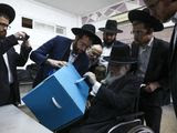 Ultra-orthodox man votes during elections in Bnei Brak, Israel, Monday, March 2, 2020. (AP Photo/Oded Balilty)