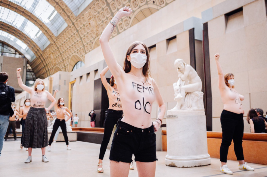 Feminists pose topless to protest after a woman was denied entry to museum over