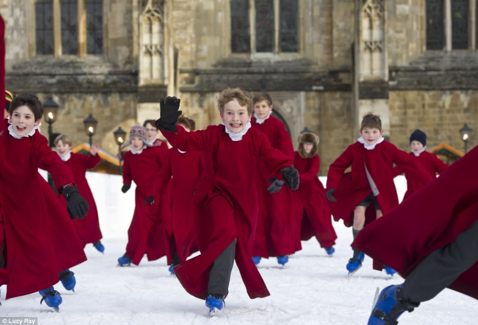Seasons greetings: The choir boys of Winchester Cathedral braved the ice skating rink - despite some wearing shorts in the freezing temperatures