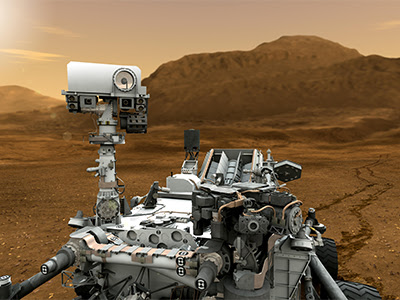 Illustration shows NASA’s Curiosity rover on Mars, with its camera mast looking toward the viewer. In the background, wheel tracks it has made in the surface recede toward brownish-red scalloped mountains, and a pinkish orange sky with wispy clouds.