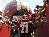 Washington Redskins tackle Trent Williams (71) greets fans as he prepares to enter the field before an NFL football game against the Miami Dolphins, Sunday, Sept. 13, 2015, in Landover, Md. (AP Photo/Alex Brandon) **FILE** 