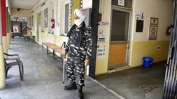  A CISF jawan guards an empty vaccination site at Navyug School, Pandara Park, in Delhi on Friday.