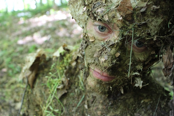 natural camouflage on face mud and leaves