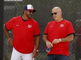 Washington Nationals manager Dave Martinez, left, talks with general manager Mike Rizzo during spring training baseball practice Monday, Feb. 17, 2020, in West Palm Beach, Fla. (AP Photo/Jeff Roberson)