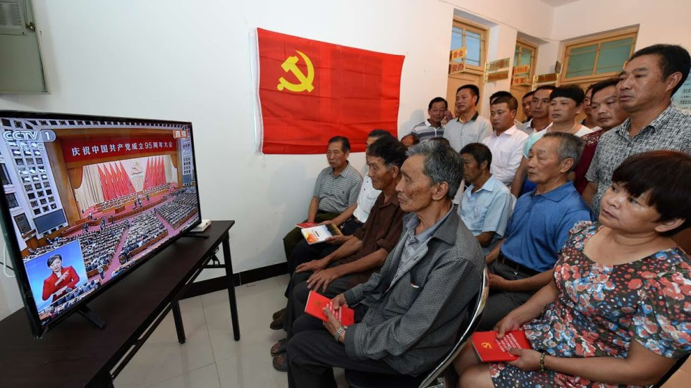 Members of the Communist Party watch the live broadcast of a gathering celebrating the 95th anniversary of the party’s founding, in Xinfeng village, Yongtai county,in Fujian province. Photo: Xinhua