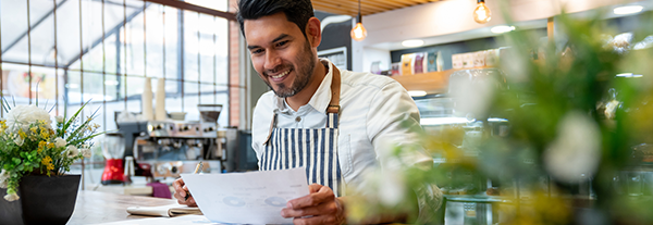 Cafe owner working on his weekly payroll