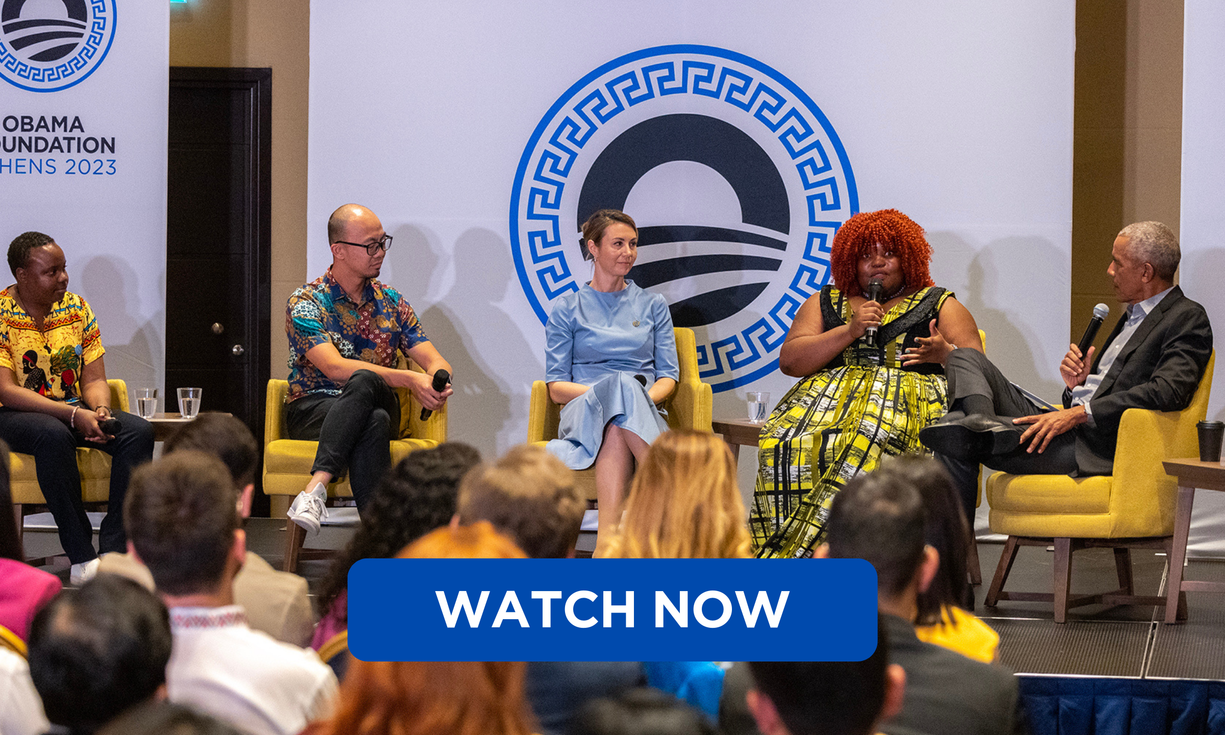 Four people with a range of skin tones and hair types, including President Obama on the far right, are seated in yellow armchairs and looking toward the woman seated next to President Obama, who is holding a microphone and speaking. 