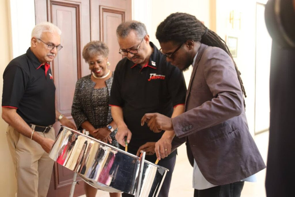 WHO Director General Dr Tedros Adhanom Ghebreyesus learns to play the steelpan while Health Minister Terrence Deyalsingh and Speaker Brigid Annisette-George look on during a visit to the Red House on Friday. Photo courtesy the Ministry of Health. -