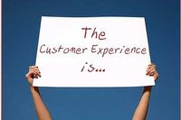 Photo of someone holding up a sign that says Customer experience is