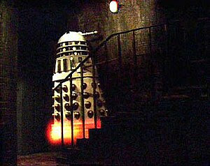 An Imperial Dalek flies up a flight of stairs ...