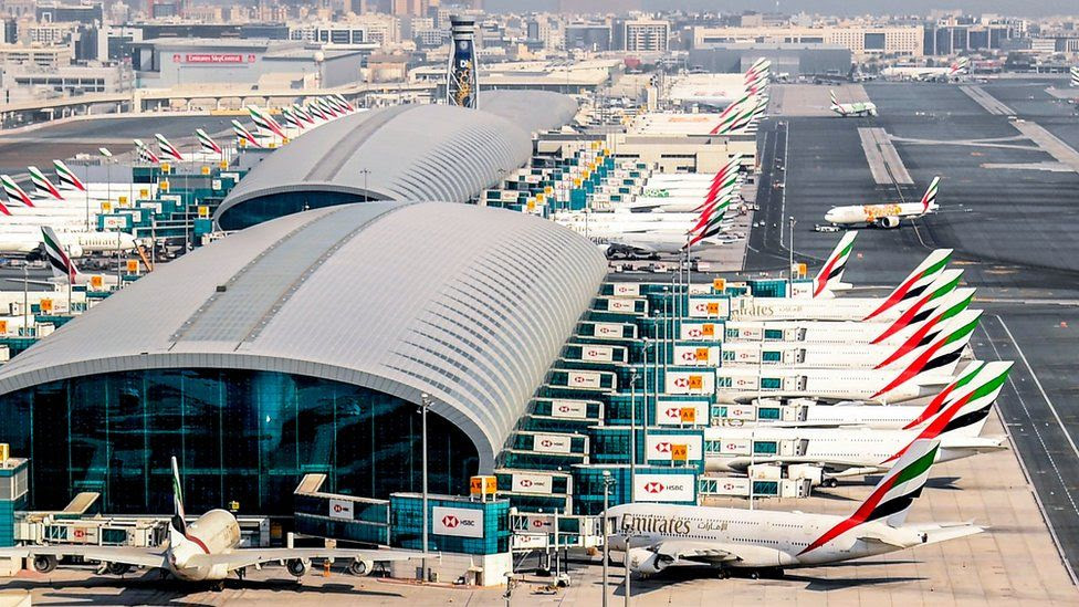 Lots of Emirates planes parked at a Dubai airport terminal