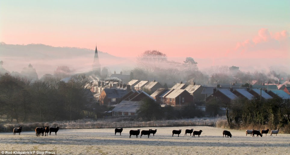 After temperatures plummeted overnight, the first rays of sunshine can be seen as dawn breaks over a misty Rocester, near Uttoxeter, Staffordshire