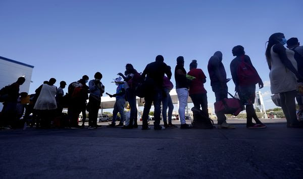 Migrants, mostly from Haiti, wait for a bus after they were processed and released after spending time at a makeshift camp near the International Bridge, Sunday, Sept. 19, 2021, in Del Rio, Texas. President Joe Biden&#39;s administration is nearing a final plan to expel many of the thousands of Haitian migrants who have suddenly crossed into a Texas border city from Mexico and to fly them back to their Caribbean homeland. (AP Photo/Eric Gay)