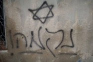 Graffiti found on the burned home in the village of Duma.