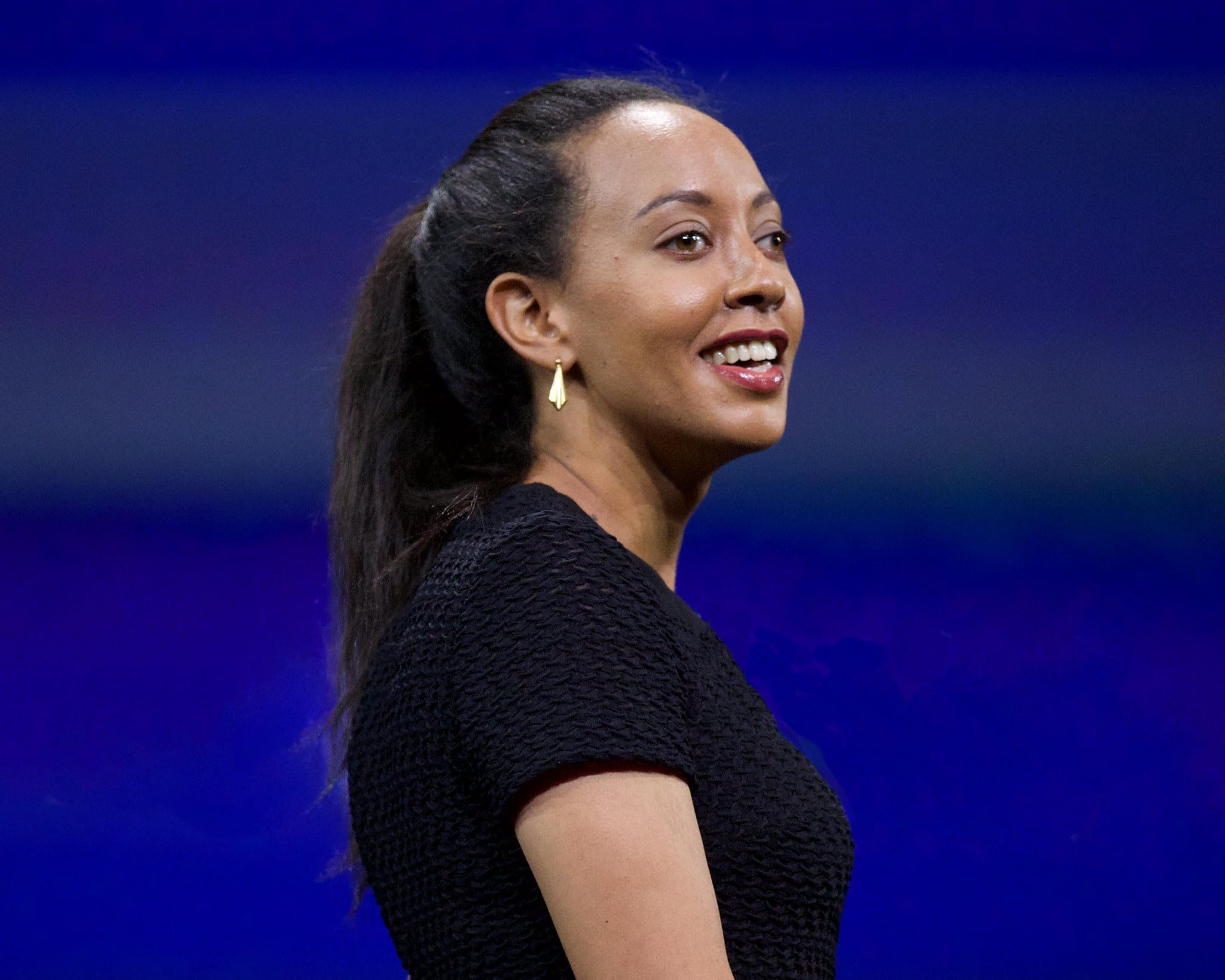 Haben Girma, a woman with long black hair and a black shirt with red
lipstick. 