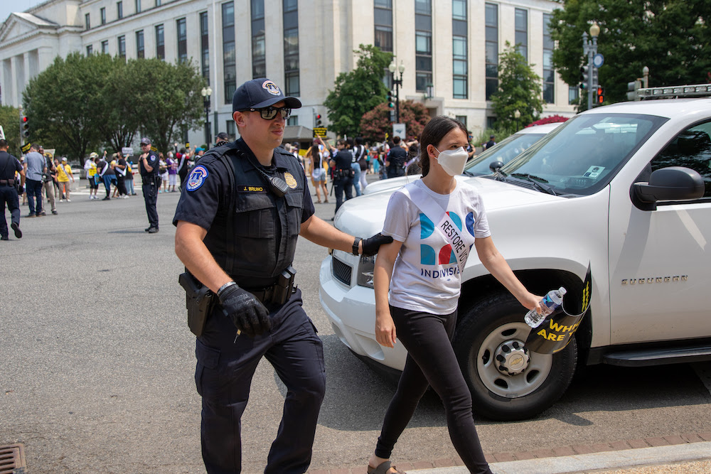 Leah being arrested by Capitol Police outside of the Supreme Court in Washington, DC.