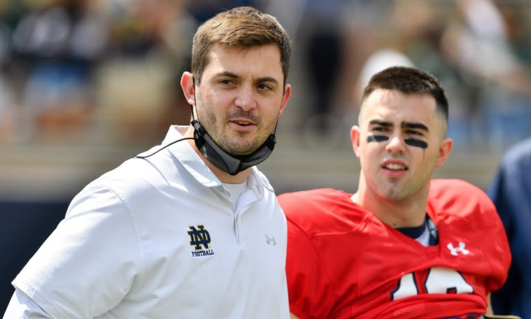 Tommy Rees standing next to Notre Dame QB Drew Pyne in the 2021 spring game.