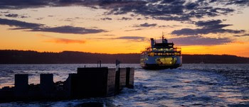 Photo of ferry with sunset in background