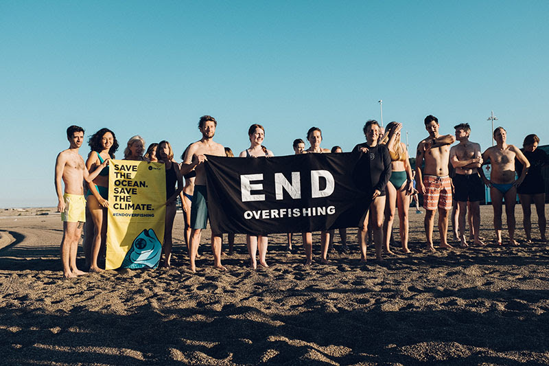Swimmers with a poster in defence of oceans